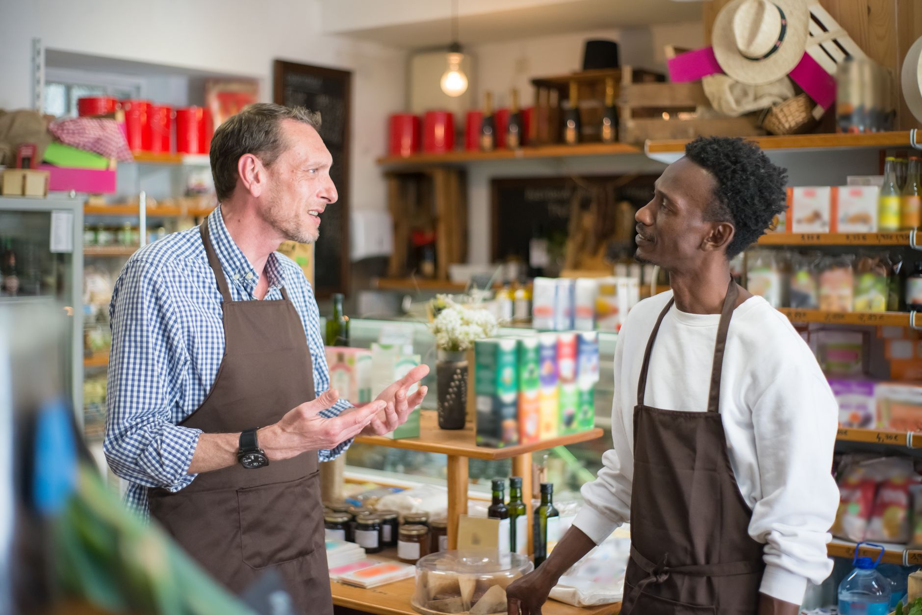 entrepreneur talking with happy customer in local store